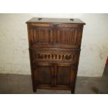 AN OAK PRIORY STYLE DRINKS CABINET