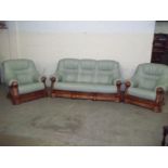 A LEATHER THREE PIECE SUITE WITH OAK FRAME