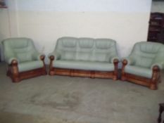 A LEATHER THREE PIECE SUITE WITH OAK FRAME