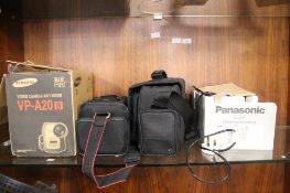 A PANASONIC VHS VIDEO CAMERA WITH BAG AND INSTRUCTIONS TOGETHER WITH A SAMSUNG VIDEO CAMERA RECORDER