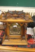 A WOODEN MANTLE CLOCK WITH PART BRASS BASE WITH BARLEY TWIST SIDE SUPPORTS WITH PENDELOM NO KEY ,