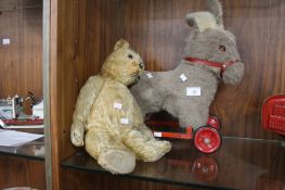 A VINTAGE PUSH ALONG HORSE TOGETHER WITH A VINTAGE TEDDY BEAR