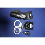 PAIR OF HANDCUFFS WITH KEYS IN A LEATHER POUCH, LEATHER HOLSTER AND A MINIATURE PISTOL TORCH