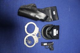 PAIR OF HANDCUFFS WITH KEYS IN A LEATHER POUCH, LEATHER HOLSTER AND A MINIATURE PISTOL TORCH