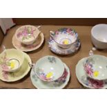 A SMALL TAY OF ASSORTED CUPS AND SAUCERS