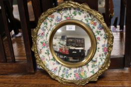 A GILT MOUNTED MIRROR WITH CERAMIC BORDER