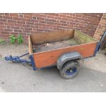 A WOOD PANELLED CAR TRAILER
