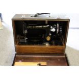 A VINTAGE CASED SINGER SEWING MACHINE