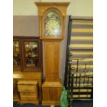 A MODERN HONEY PINE LONGCASE CLOCK WITH WEIGHTS AND PENDULUM