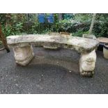 A CURVED CONCRETE GARDEN SEAT WITH LION PLINTHS