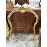 A SHAPED CANTHUS SCROLL GILT FINISHED PICTURE FRAME A/F