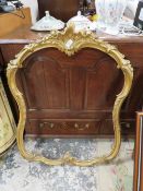 A SHAPED CANTHUS SCROLL GILT FINISHED PICTURE FRAME A/F