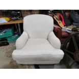 A MODERN UPHOLSTERED ARMCHAIR