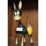 A VINTAGE WOODEN MONEY BOX IN THE SHAPE OF A DONKEY