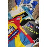 A TRAY OF ASSORTED VINTAGE CYCLING JERSEYS TO INCLUDE NORTHERN IRELAND MILK RACE POINT LEADER JERSEY