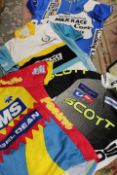 A TRAY OF ASSORTED VINTAGE CYCLING JERSEYS TO INCLUDE NORTHERN IRELAND MILK RACE POINT LEADER JERSEY
