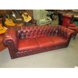 AN OXBLOOD RED LEATHER CHESTERFIELD