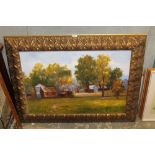 LARGE GILT FRAMED OIL ON CANVAS BUILDINGS IN A RURAL LANDSCAPE, SIGNED LOWER RIGHT