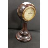 A WOODEN TURNED H.A.C. DESK CLOCK