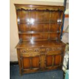 A VINTAGE OAK CARVED WELSH STYLE DRESSER W-128 CM