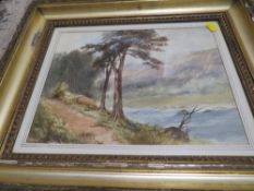 A FRAMED AND GLAZED WATERCOLOUR OF AN ESTUARY SCENE WITH CASTLE RUINS IN THE BACKGROUND SIGNED LOWER