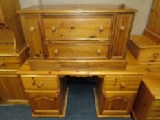 A MODERN HONEY PINE TWIN PEDESTAL DESK & A TV CABINET (2)