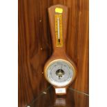 A SMALL WALL MOUNTED BAROMETER