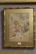 A BAMBOO STYLE GILT FRAMED AND GLAZED JAPANESE BLOCK PRINT OF A LADY AND HER TWO ASSISTANTS