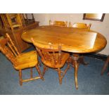 A HONEY PINE OVAL KITCHEN TABLE AND FOUR CHAIRS