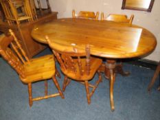 A HONEY PINE OVAL KITCHEN TABLE AND FOUR CHAIRS
