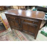 AN ERCOL STYLE DARK OAK SIDEBOARD