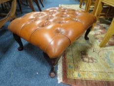 A LEATHER FOOTSTOOL