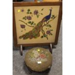 A VINTAGE OAK FIRESCREEN WITH PEACOCK DESIGN TOGETHER WITH A CARVED TAPESTRY TOP MAHOGANY FOOT