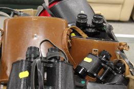 A TRAY OF ASSORTED CASED BINOCULARS , CAMERAS ETC