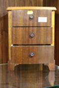 A VINTAGE MINIATURE CHEST OF DRAWERS
