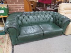 A GREEN LEATHER CHESTERFIELD SETTEE