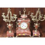 A FRENCH STYLE RED MARBLE AND GILT METAL CANDELABRA CLOCK GARNITURE