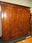 A LARGE VICTORIAN MAHOGANY TRIPLE WARDROBE W 214 CM