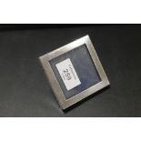 A SMALL SQUARE HALLMARKED SILVER PICTURE FRAME