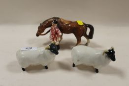 TWO BESWICK SHEEP TOGETHER WITH AN UNMARKED HUNTSMAN FIGURE (3)