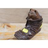 A VINTAGE WOODEN INKWELL IN THE FORM OF A CAT PEEPING OUT OF A SHOE