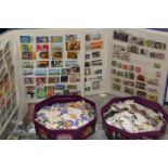 A BOX CONTAINING THREE STAMP ALBUMS AND TWO TUBS OF LOOSE STAMPS