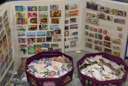 A BOX CONTAINING THREE STAMP ALBUMS AND TWO TUBS OF LOOSE STAMPS