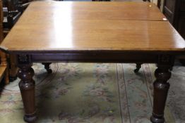 A LARGE VICTORIAN EXTENDING WIND-OUT DINING TABLE WITH TWO SPARE LEAVES - EBONISED WITH FLORAL