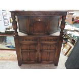 A VINTAGE OAK COURT CUPBOARD