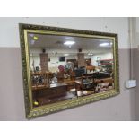 A MODERN GILT FRAMED WALL MIRROR 66 X 96 CM