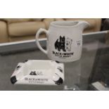 A VINTAGE BLACK AND WHITE WHISKY JUG AND MATCHING ASHTRAY