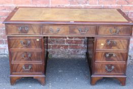 A REPRODUCTION MAHOGANY LEATHER TOPPED TWIN PEDESTAL DESK - W 137 CM