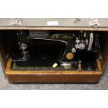 A VINTAGE CASED SINGER SEWING MACHINE MODEL NUMBER EA843385