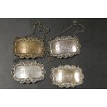 FOUR HALLMARKED SILVER WINE LABLES